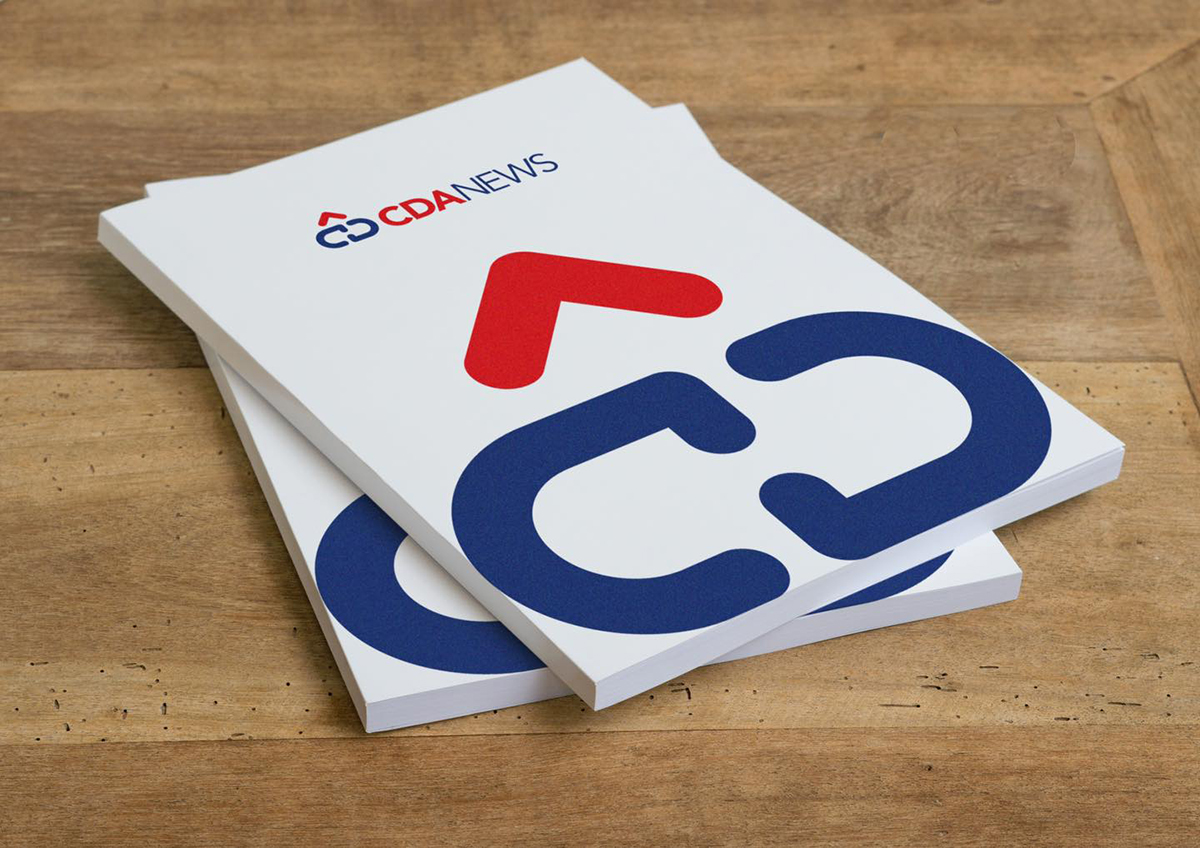 CDA News logo design printed on a booklet